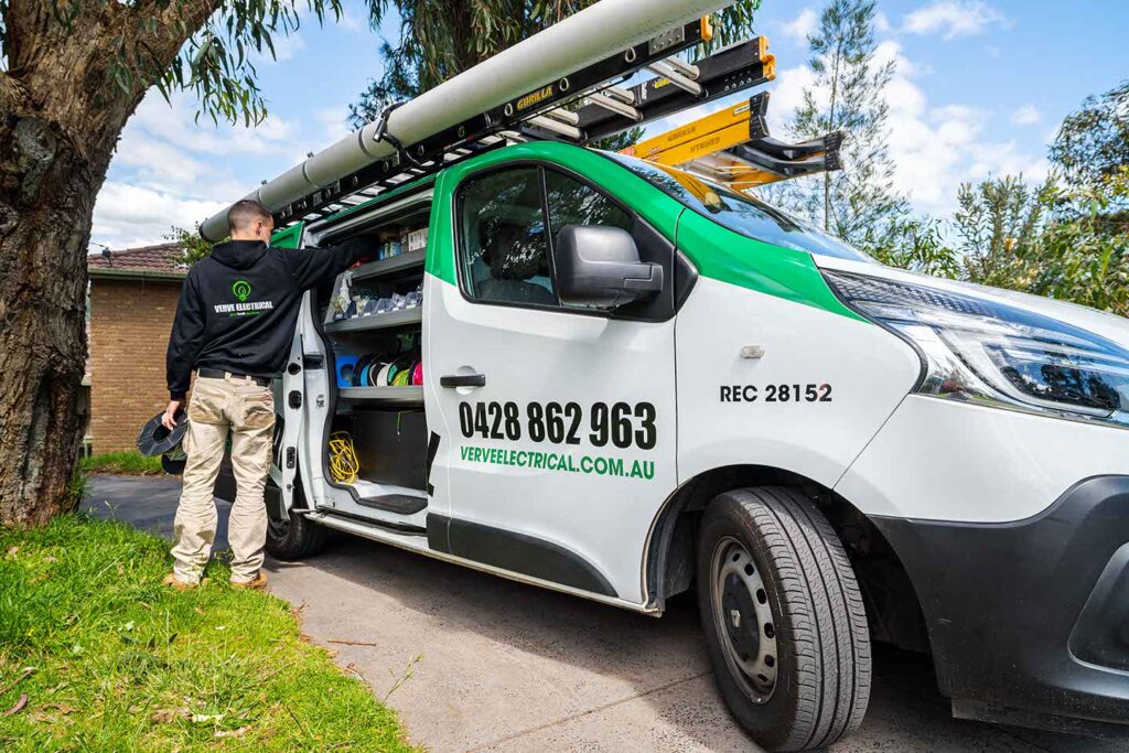 electrician in croydon getting ceiling fan out of his van for a job